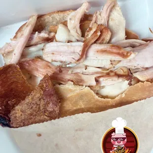 a sandwich with meat and cheese