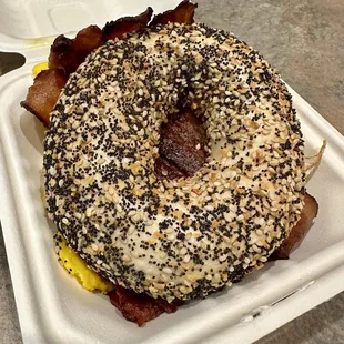 a bagel with bacon and eggs