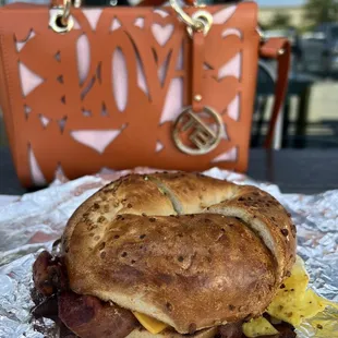 The garlic bagel with cheese, bacon and eggs