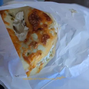a sandwich wrapped in paper