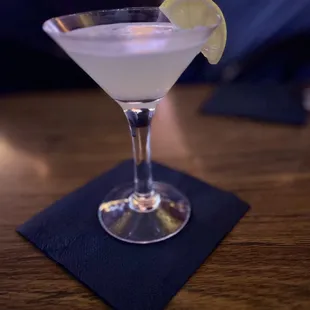 a martini with a slice of lemon on the rim