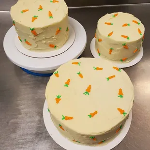 three cakes with carrots on them