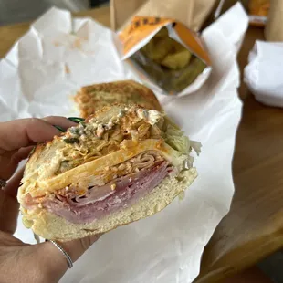 a person holding a sandwich