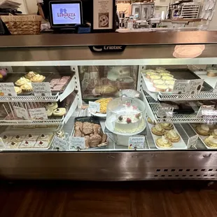 Display case of cupcakes, pies, creme brûlée, panna cotta, etcetera