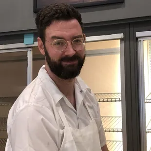 Baker Sam shows off glazed donuts