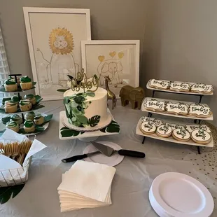 a table with a cake and cupcakes