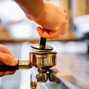 a person using a coffee grinder