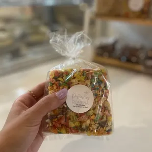 a hand holding a bag of food