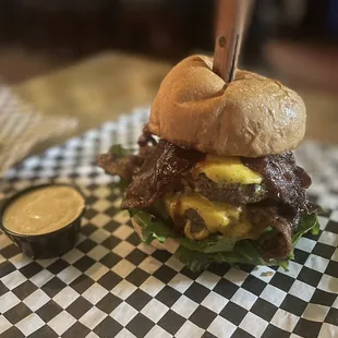 a burger on a checkered napkin