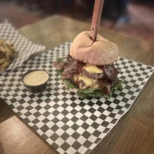 a burger with a knife sticking out of it