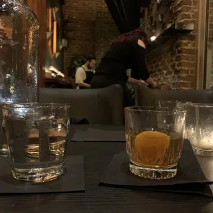 a glass of whiskey and a bottle of water