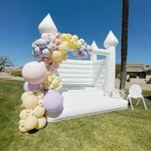White bounce house with garland