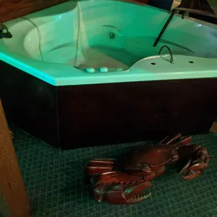A strange hot tub with large plastic crabs around it