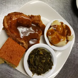 Smothered fried pork chop, mixed greens, mashed potatoes/gravy, and sweet cornbread.