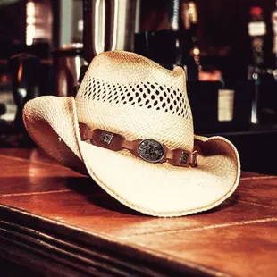 a cowboy hat on a bar