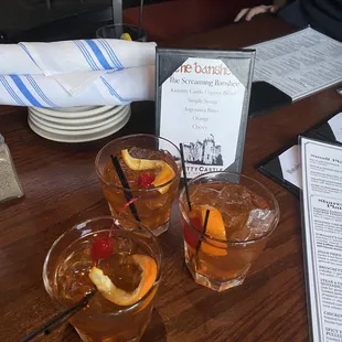 three glasses of drink on a table