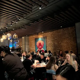 a large group of people sitting at tables in a restaurant