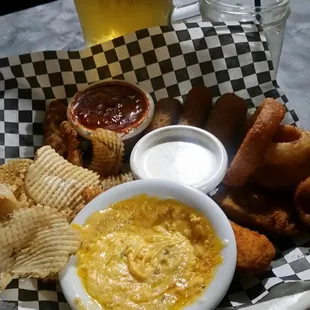 Sampler with chips and queso, chicken wings, onion rings, mozzerrella sticks , and jalapeno poppers