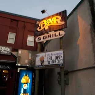 the neon sign for the bar and grill