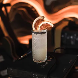 a cocktail with a slice of orange