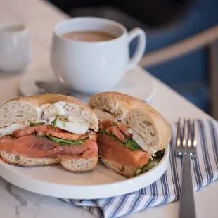 a plate with a sandwich and a cup of coffee