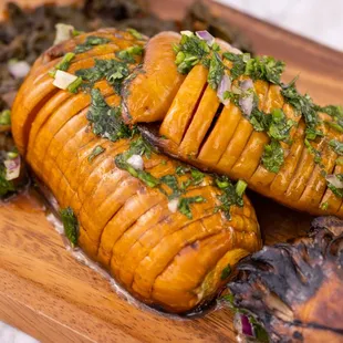 Hasselback Acorn Squash with chipotle braised beet greens and mushrooms.