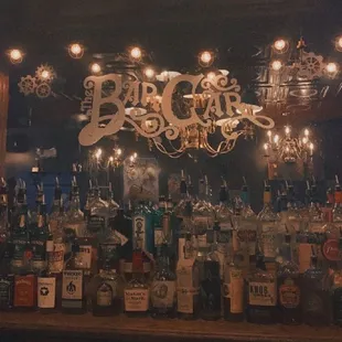 a chandelier and liquor bottles