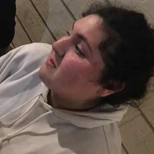 a woman sitting on a wooden floor
