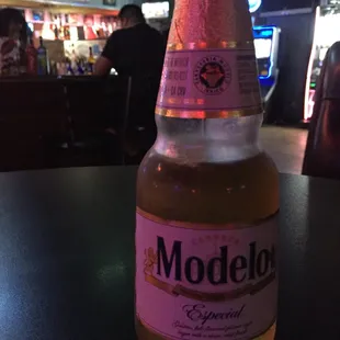a bottle of modelo beer on a table