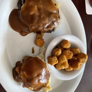 Sirloin chopped steak with brown gravy and onions, mashed potatoes and fried okra