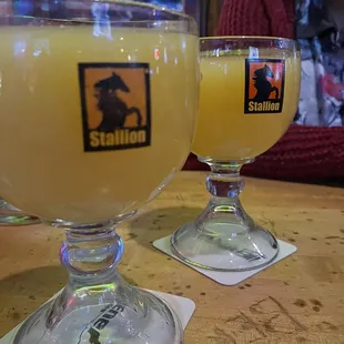 two glasses of orange juice on a table