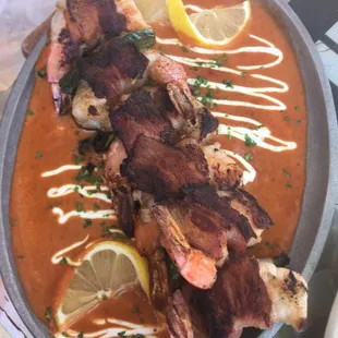 Bacon wrapped jumbo shrimp with jalapeño on a chipotle cream sauce.