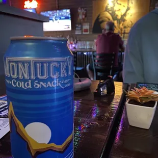 a can of beer on the bar