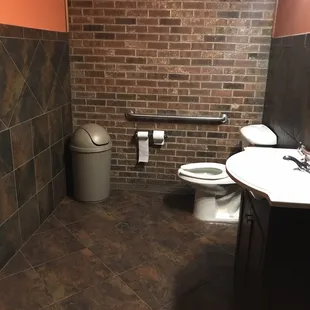a toilet, sink, and trash can