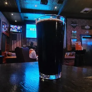 a pint of beer on a bar table