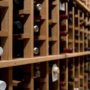 rows of wine bottles in a wine cellar