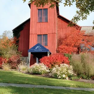 a red barn with a blue awning