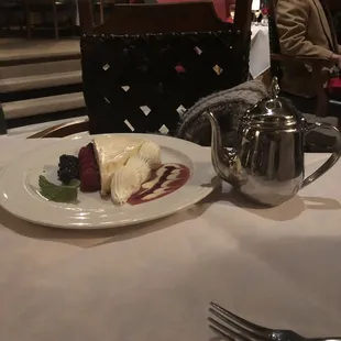 a plate of dessert and a teapot