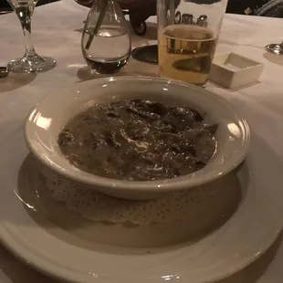 a bowl of soup and a glass of wine