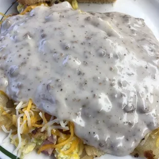 Barn skillet. Egg, ham, green pepper, cheese, home fries covered with sausage gravy.