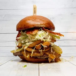 Lasso Burger: Brioche Bun, Hickory BBQ, Angus Patty, Cheddar Cheese, Caramelized Onions, Pickles, Fried Onion Straws, Shredded Lettuce Bacon