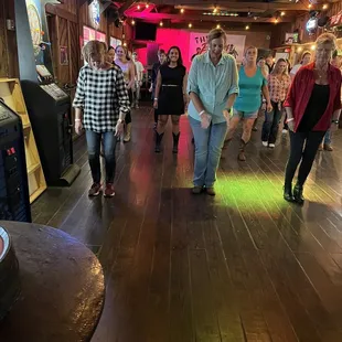  a group of people dancing in a barn