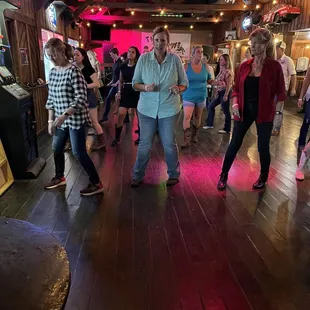  a group of people dancing in a barn