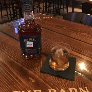 a glass of whiskey on a wooden table