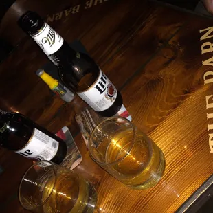 three bottles of beer on a wooden table