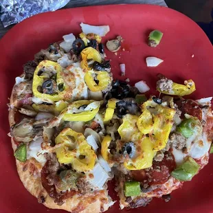 Loaded personal pizza with pepperoni, peppers, sausage, and anything else you can think of.