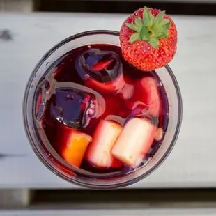a glass of sangico with a strawberry on top