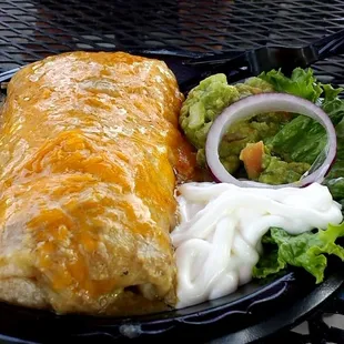 Chili Verde Burrito with homemade guacamole @ Match point Grill on the patio.
