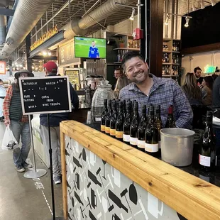 a man standing behind a bar