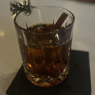 a glass of whiskey on a napkin